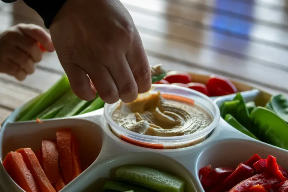 Bowl of homemade hummus served with fresh vegetables