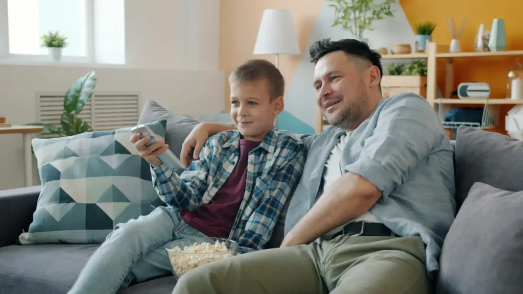 healthy snack recipes - father & son eating popcorn