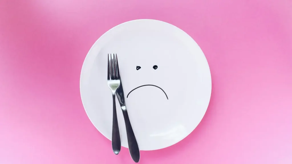 Intermittent fasting unhappy face on a plate