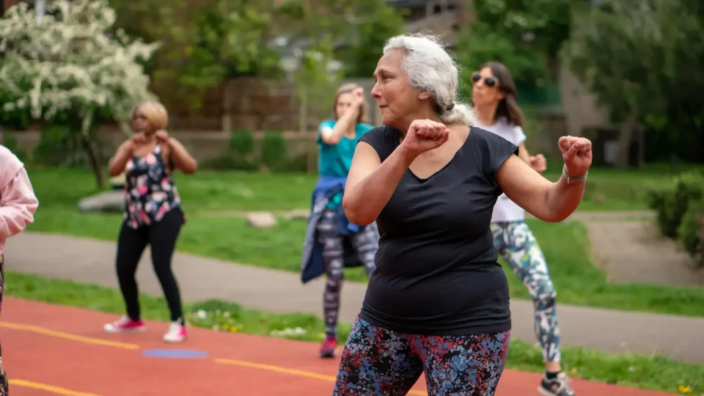 Fitness for Older Adults - Elderly people exercising in a park.
