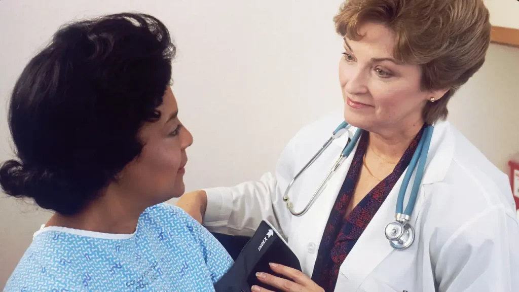 Healthcare professional discussing type 2 diabetes and blood glucose testing with a patient