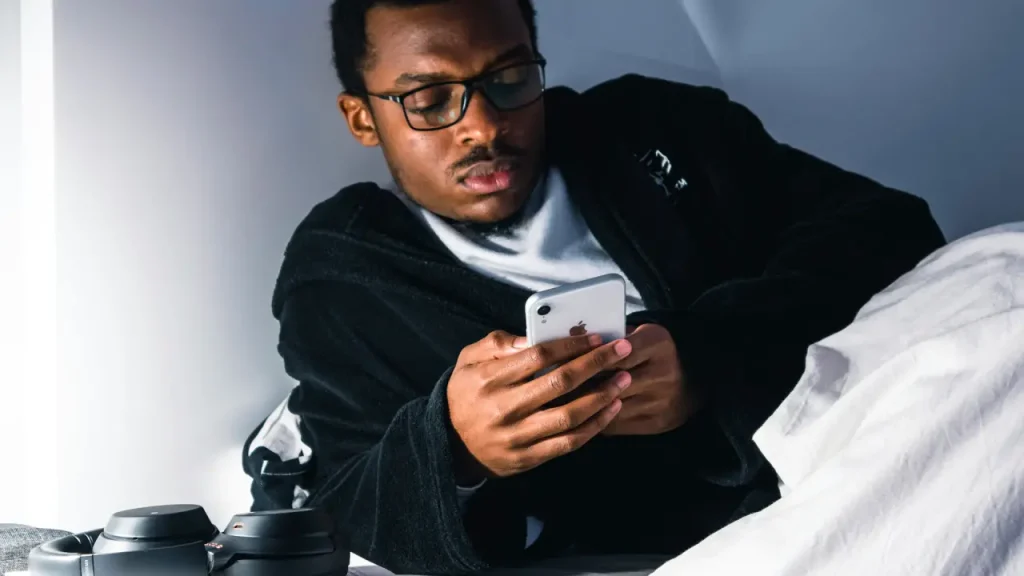 Insomnia Man playing on his phone in the middle of the night